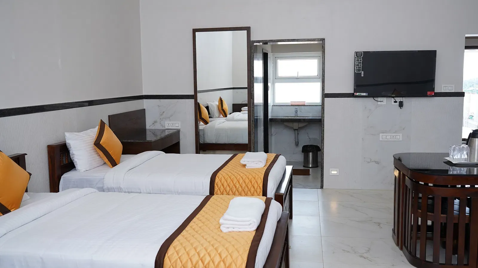 Clean and luxurious bed setting at Ketti Heights – a standout among luxury resorts in Ooty