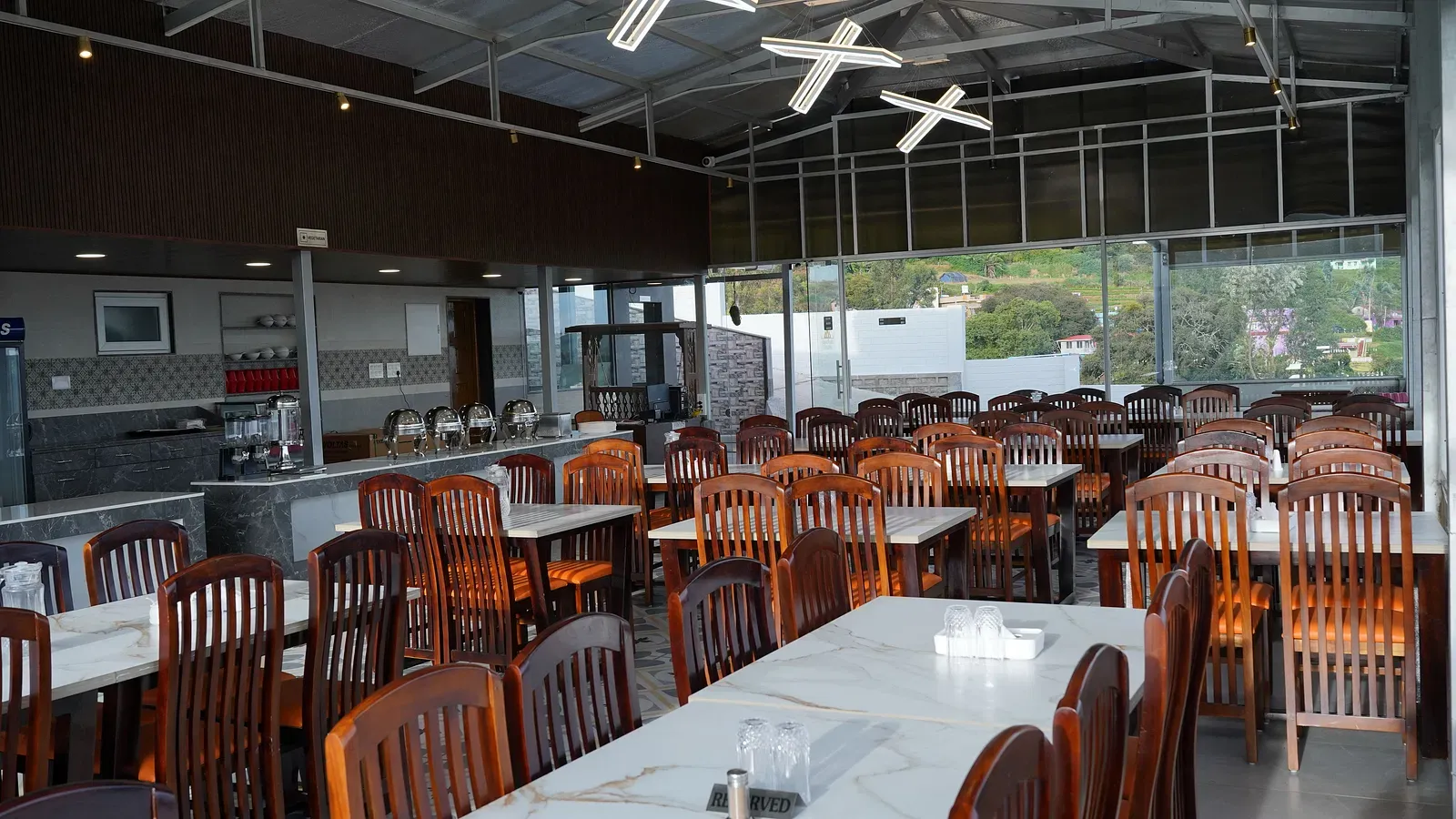 Comfortable seating and serene ambiance in Ketti Heights cafeteria – ideal resort dining experience in Ooty