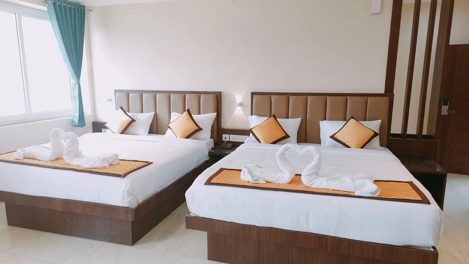 Elegant double bed in a luxury room at Ketti Heights – one of the best resorts in Ooty hills