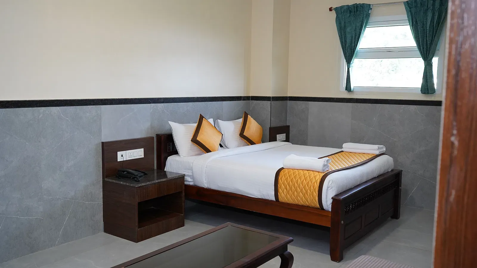 Elegant bed setup in Ketti Heights resort room – perfect for family vacations in Ooty